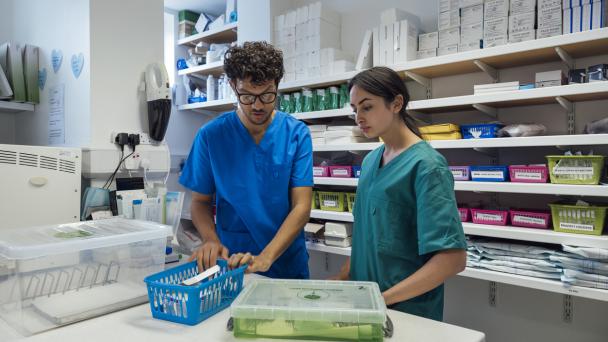 Healthcare professionals working in a medication store room or chemist.